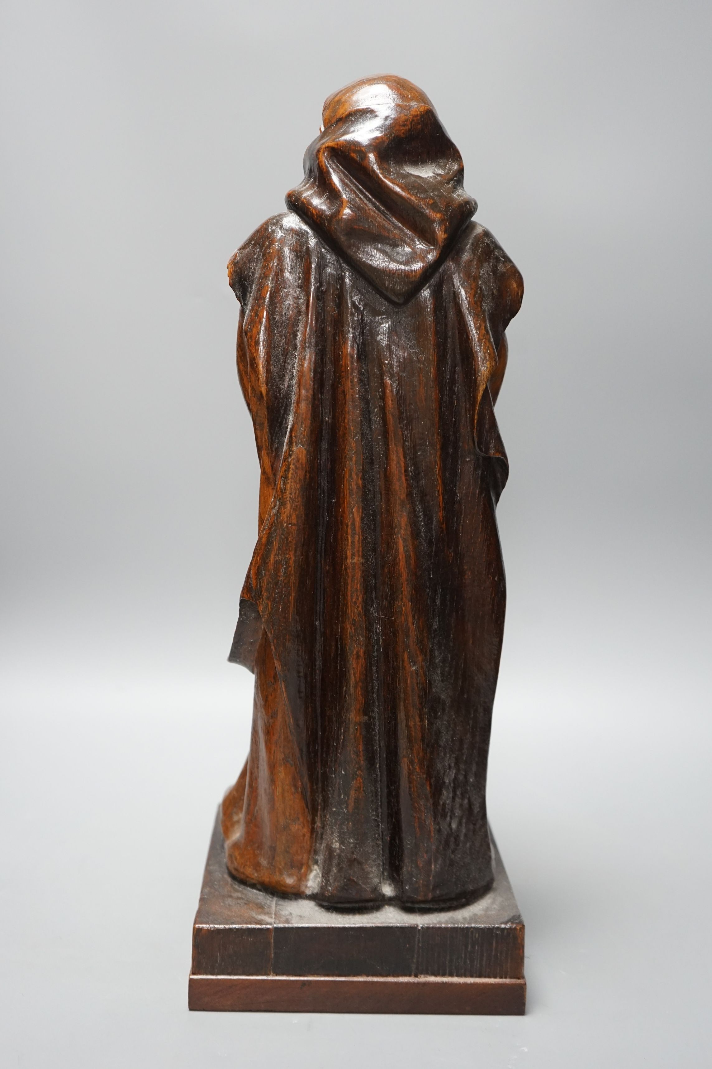 A carved wooden figure of a friar, 48cms high